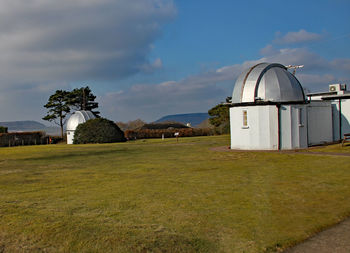 Built structure on field against sky