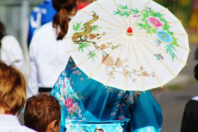 Rear view of woman wearing kimono with umbrella