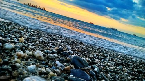 Scenic view of beach against sky during sunset