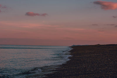 Scenic view of sea against orange sky