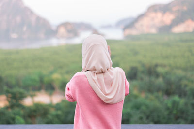 Rear view of woman in headscarf standing outdoors