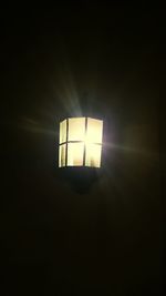 Low angle view of lit lamp