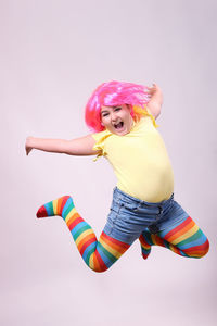 Low angle view of woman against pink background