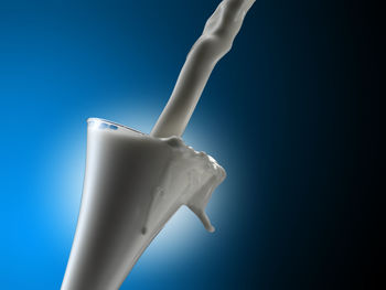 Close-up of drink in glass against blue background