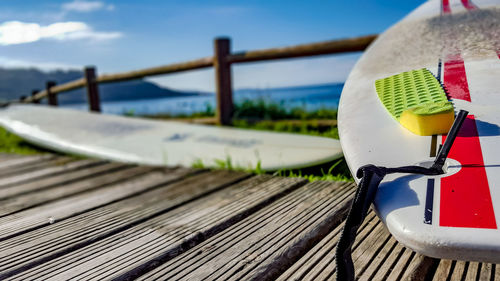 Close-up of boat moored at beach against sky