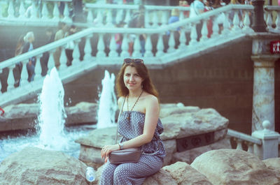 Portrait of woman sitting outdoors