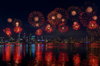 Firework display over city at night