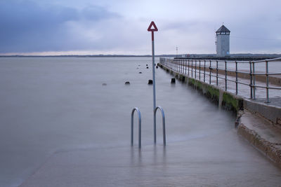 Pier on sea against sky