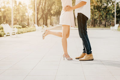 Low section of woman walking on street