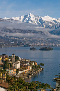 High angle view of city by sea against sky