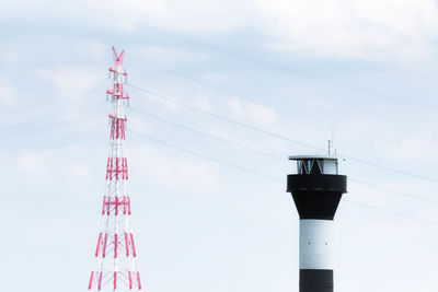 Low angle view of communications tower against sky