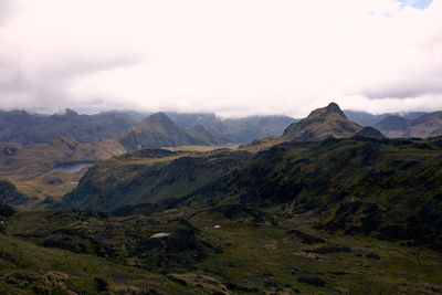 Scenic view of mountains against cloudy sky