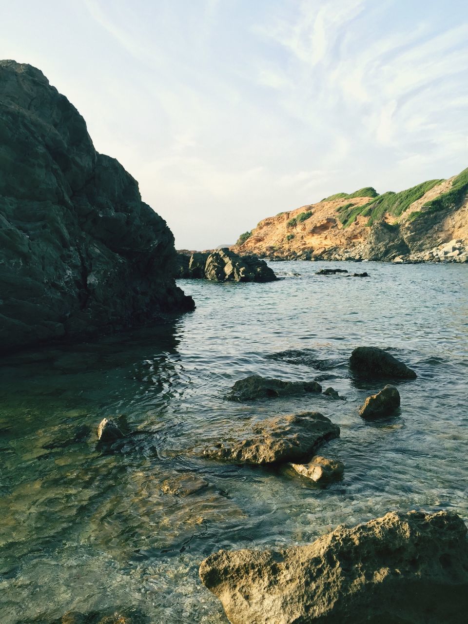 water, sky, tranquil scene, tranquility, scenics, mountain, beauty in nature, sea, rock - object, nature, rock formation, cloud - sky, idyllic, cloud, lake, day, outdoors, non-urban scene, rock, no people