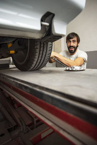 Portrait of man repairing car in factory