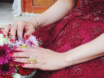 Close-up of woman hand holding pink flower