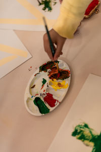 Cropped hand of person preparing food on table