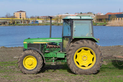 Yellow tractor on road against the sky