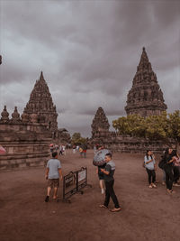 People at temple against sky