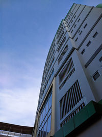 Low angle view of modern building against blue sky