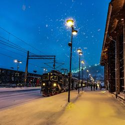 Illuminated street lights in city at night