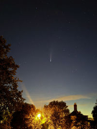 Comet neowise pictured above house trees