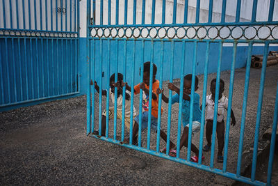 People standing by railing in city