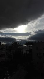 Buildings against cloudy sky