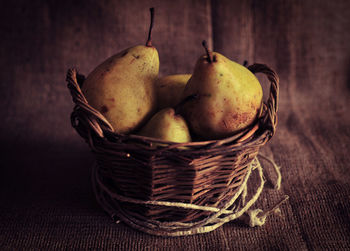 Close-up of pears in basket on sack