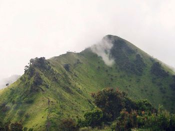 Scenic view of mountains against cloudy sky