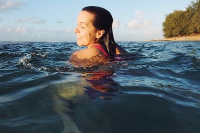 Side view of a woman swimming in sea