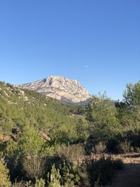 Scenic view of mountains against clear blue sky