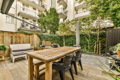 Empty chairs and tables in yard