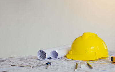 Close-up of yellow hat on table against gray background