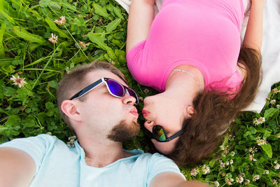 Midsection of woman lying on grass