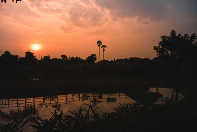 Scenic view of lake against orange sky