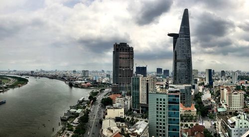 View of cityscape against cloudy sky