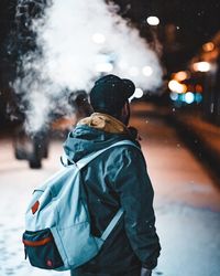 Rear view of man on street during winter