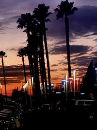 Silhouette palm trees against sky during sunset