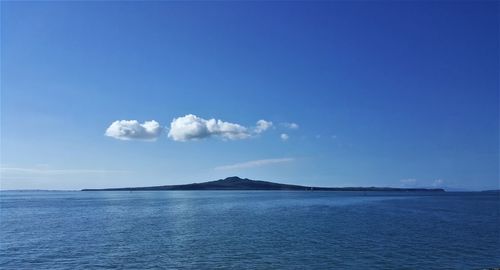 Scenic view of sea against blue sky