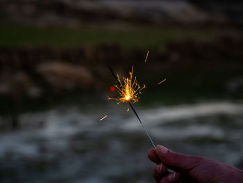 Low angle view of person holding sparkler