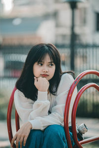 Portrait of woman sitting outdoors