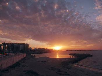 Scenic view of beach against sky during sunset