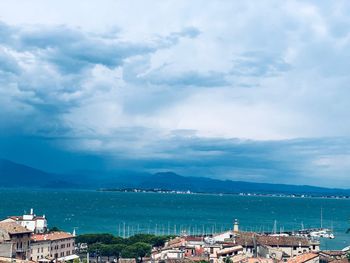 Scenic view of sea by city against sky