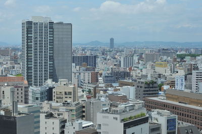 High angle view of modern buildings in city against sky