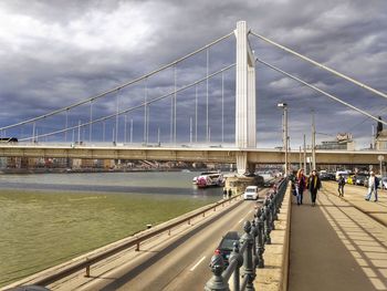 Bridge over road against sky in city