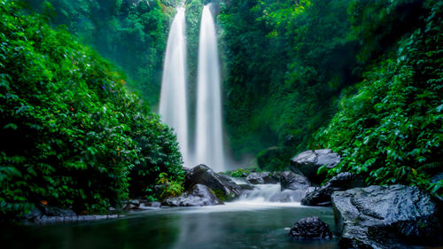 Scenic view of waterfall against sky