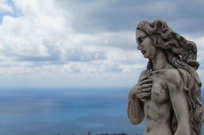 Statue of angel against sky