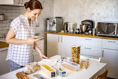 Woman standing in kitchen