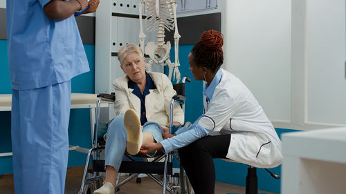 Doctor examining patient in clinic