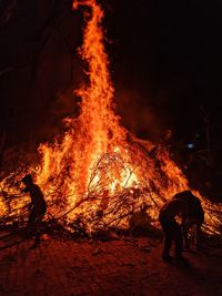 People by bonfire at night